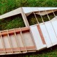 The starboard wheel bay at the stage where metal skinning can begin. Inevitably, the delicate ply supports spanning the roof of the wheel bay received damage during construction. Note how they have been repeatedly braced either side where breakages happened.